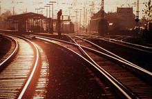 Railroad Tracks At Station During Sunset