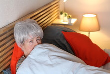 Terrified Senior Woman In Bed