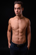 © Ranta Images - Young handsome multi ethnic man shirtless against black background