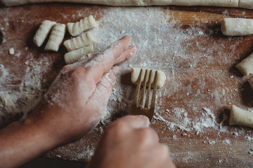 Moulding homemade gnocchi with fork