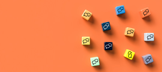 many cubes with speech bubble icons on orange background