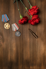 Wall Mural - Medals and flowers on wooden table for day of glory, 9 may