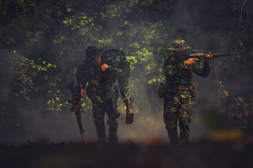 Wall Mural - army soldier with rifle and machine gun moving .Thai army soldier in combat uniforms with machine gun.