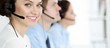 © rogerphoto - Call center. Diverse customer service operators in headsets at work in office. Business concept