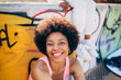© MyMicrostock/Stocksy - Afro woman hanging out in the city