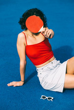 Attractive Teenager Hiding Behind Table Tennis Racket
