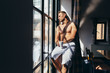 © MyMicrostock/Stocksy - Adult man enjoying the sun rays sitting besides the window in the morning