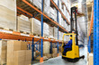 © hacohob - Huge distribution warehouse with high shelves and forklift with driver.