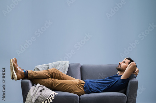 Fotografía Man Relaxing On Sofa At Home