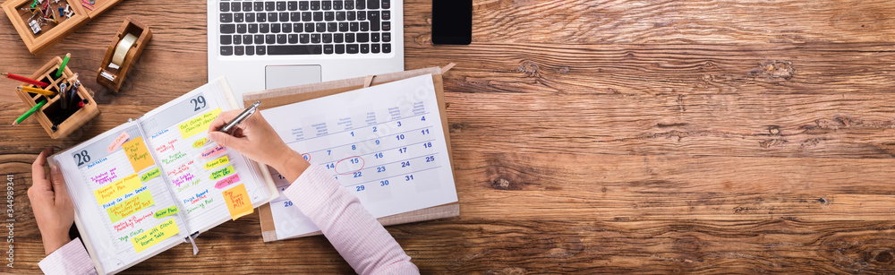 Businesswoman Writing Schedule In Calendar Diary - obrazy, fototapety, plakaty 