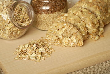 Healthy cereal, oatmeal and wheat dessert, sliced on a wooden board