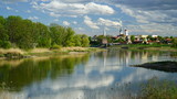 Fototapeta  - miasto wiosną nad rzeką Odrą z błękitnym niebem i burzowymi chmurami