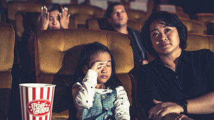 People audience watching movie in the movie theater cinema. Group recreation activity and entertainment concept.