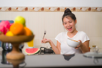 Sticker - young cute Asian woman eating healthy - beautiful and happy Chinese girl at home kitchen having lunch smiling cheerful holding food bowl in healthy nutrition