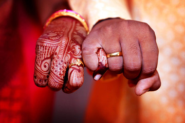 Couple_hands_with_engagement_rings