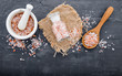  Himalayan pink salt on dark concrete background. Himalayan salt commonly used in cooking and for bath products such as bath salts.