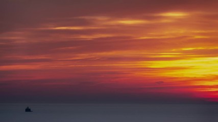 Wall Mural - panning down aerial timelapse of a beautiful soft and feathery pink, orange, blue and yellow sky sun