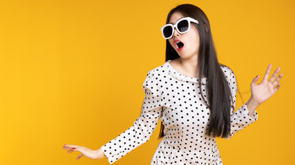 Asian woman in summer casual clothes.She smiling and  happy shopping. she  lovely attractive shine on  yellow background.Summer Surprise Sale  concept.