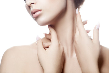 partial beauty portrait of young woman with perfect skin touching neck with sensual hands. facial tr