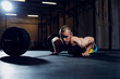 © baranq - Athletic man exercise at gym doing burpee over the bar