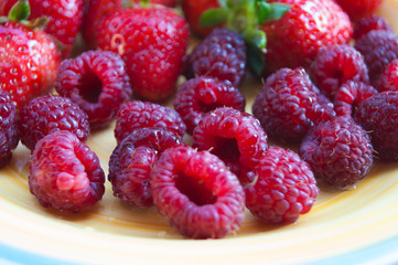 Plate with summer ripe berries - strawberries, strawberries, raspberries. Vitamin delicious simple natural vegan juicy dessert.