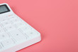 © BNMK0819 - White calculator on a bright pink background, marketing and financial concepts