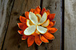 Orange peel like a flower on wooden background.