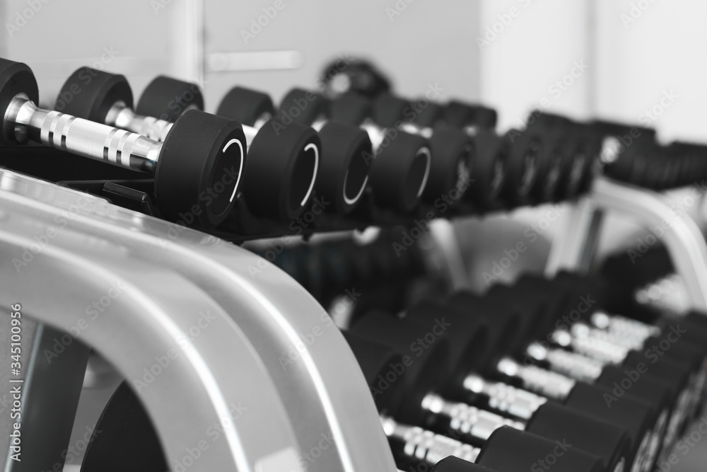 Dumbbells on stand in modern gym