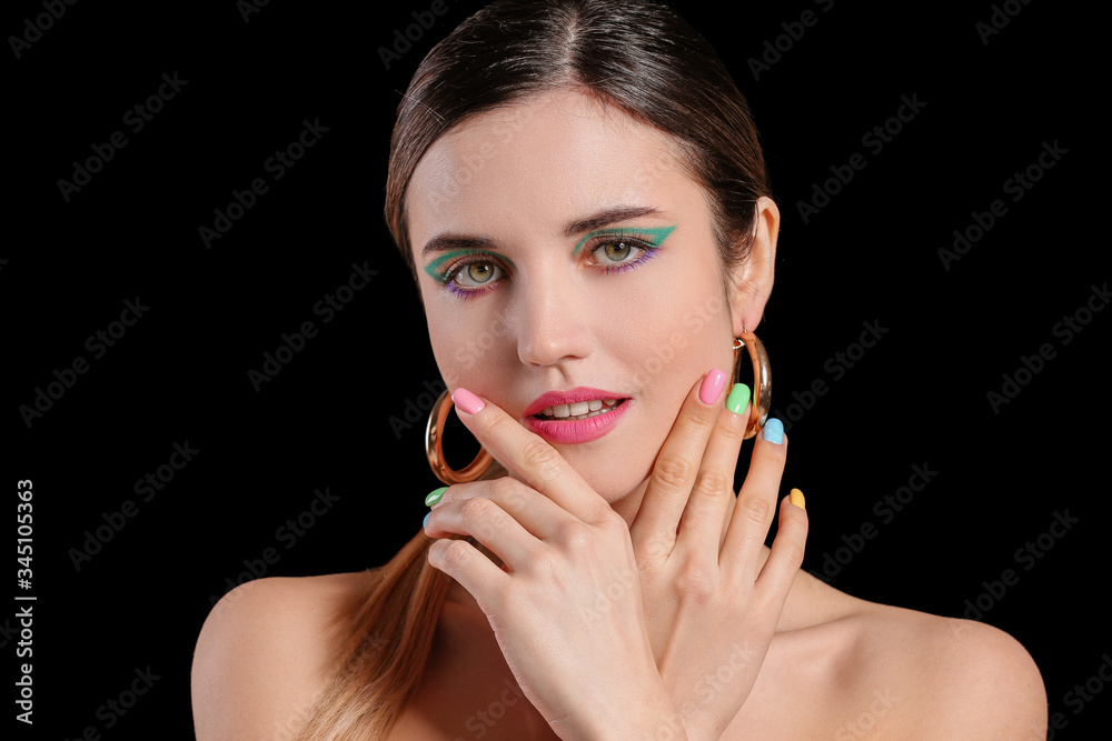 Young woman with beautiful manicure on dark background