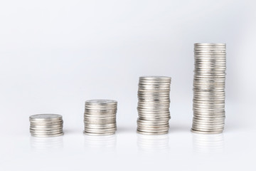 Silver Thai baht coins stacked on a white background. Money saving concept