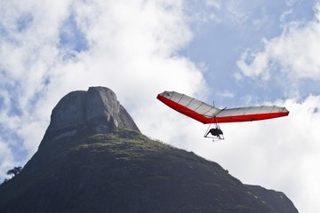 Poster - Amazing shot of human flying on a hang glider