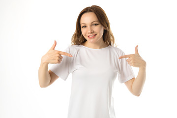 beautiful young woman in white t-shirt on a white background with hand gesture