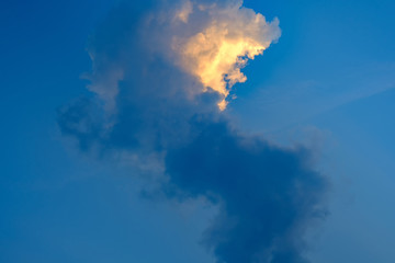 deep blue sky with vertical clouds and effect sunlight.