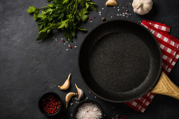 Wall Mural - Frying pan or skillet on black table.