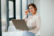 © Катя Іваськевич - portrait of young businesswoman working on laptop in the office.