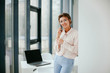 © Катя Іваськевич - happy business woman talking on the phone in the workplace.