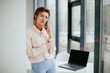 © Катя Іваськевич - happy business woman talking on the phone in the workplace.