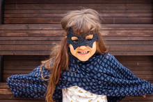 Little Girl Play In Costume Mask Of Scary Superhero Bat Or Batman. Childhood