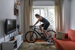 © Marina - Cyclist woman. She is training on the bike with a smart trainer at home. Stay fit and active while at home.