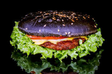 black hamburger close up on a black background