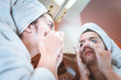 © blanke1973 - A young girl in a white bathrobe washes her face in the bathroom sink