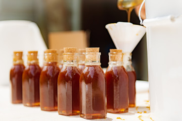 Natural raw honey being processed and bottled.