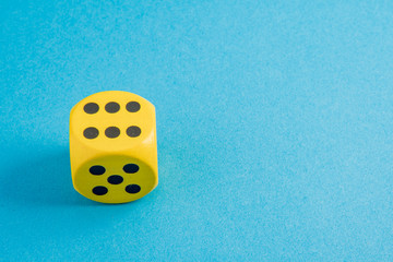 yellow cube with a six on blue