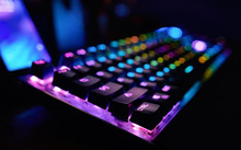 Premium Gaming RGB LED Backlit Keyboard. Mostly Purple And Blue. Side View.