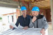 Architec and contractor checking the blue-prints on a construction site