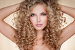 Beautiful blonde woman. Healthy Long Blond Hair. Curly Hair. Blond. Permed Hair. Afro curls. Long blond Hair.  Beauty Model Girl with Luxurious Hair.