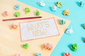 Wall Mural - Conceptual hand writing showing What S New Question. Concept meaning Asking about latest Updates Trends Happening News Colored crumpled papers empty reminder blue yellow clothespin