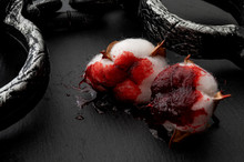 Slave Labor, Racism And Slavery Concept With Cotton Plant Covered In Blood And Locked Chains Isolated On Black Background