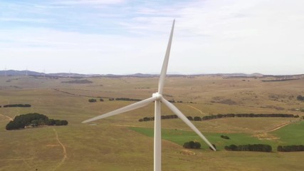 Wall Mural - aerial view sequence comprising of five shots and angles of large wind turbines rotating to create r