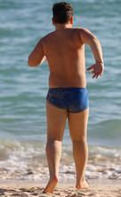 A Man In Swimming Trunks On The Seashore.